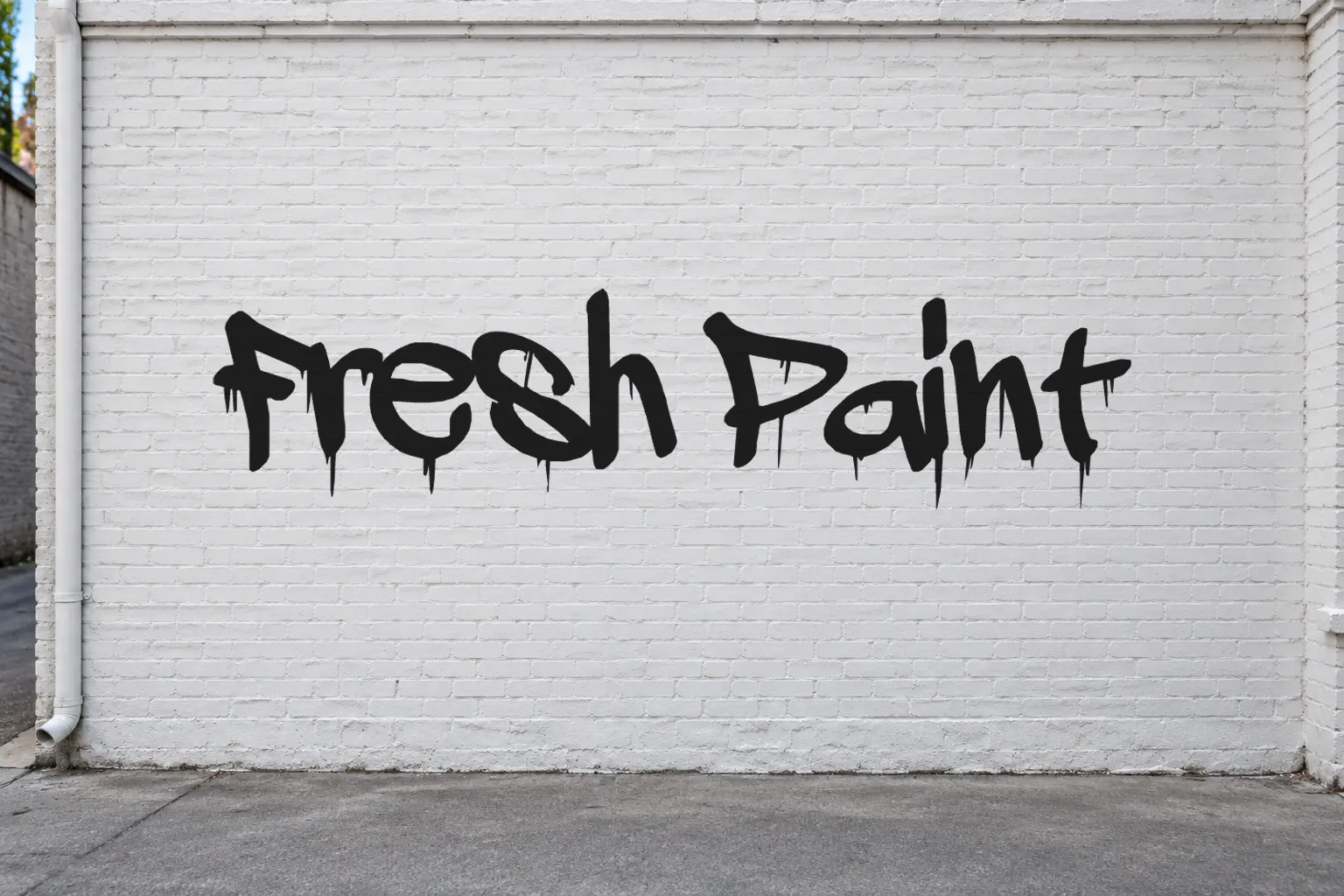 A Dripping Marker font on a white brick wall reading Fresh Paint