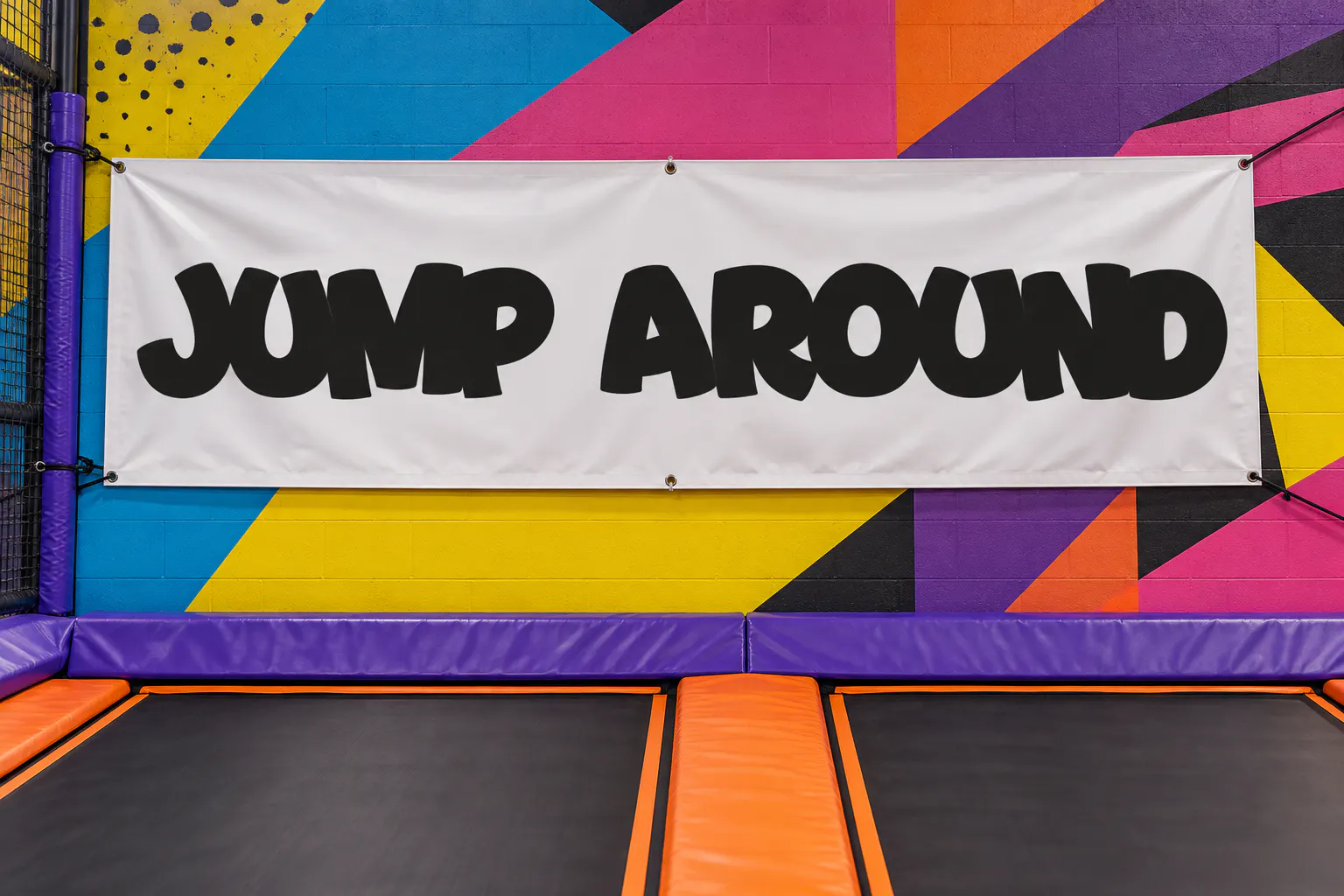 Bouncy font on a trampoline park banner reading JUMP AROUND