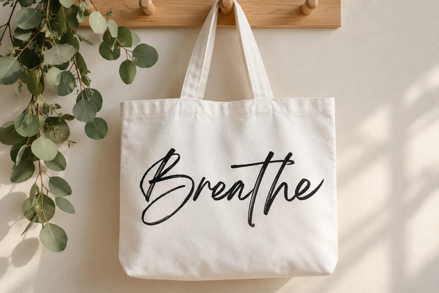 Breathing font on a canvas tote bag reading Breathe