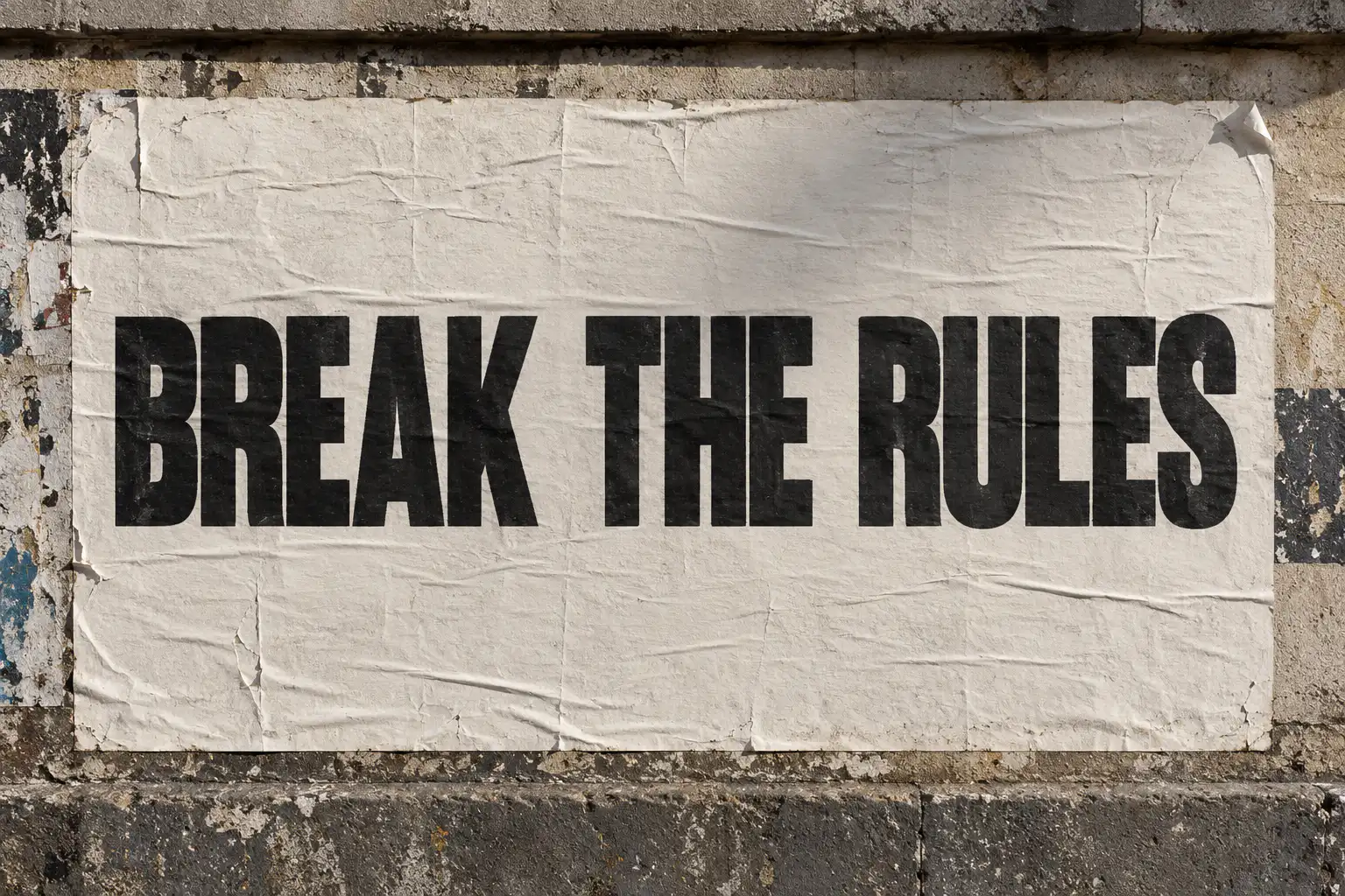 Brunson font on a city wall poster reading BREAK THE RULES