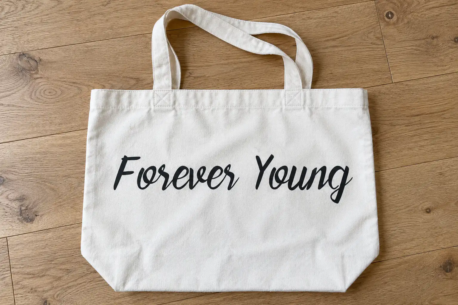 Forever Brush font on a canvas tote bag reading Forever Young