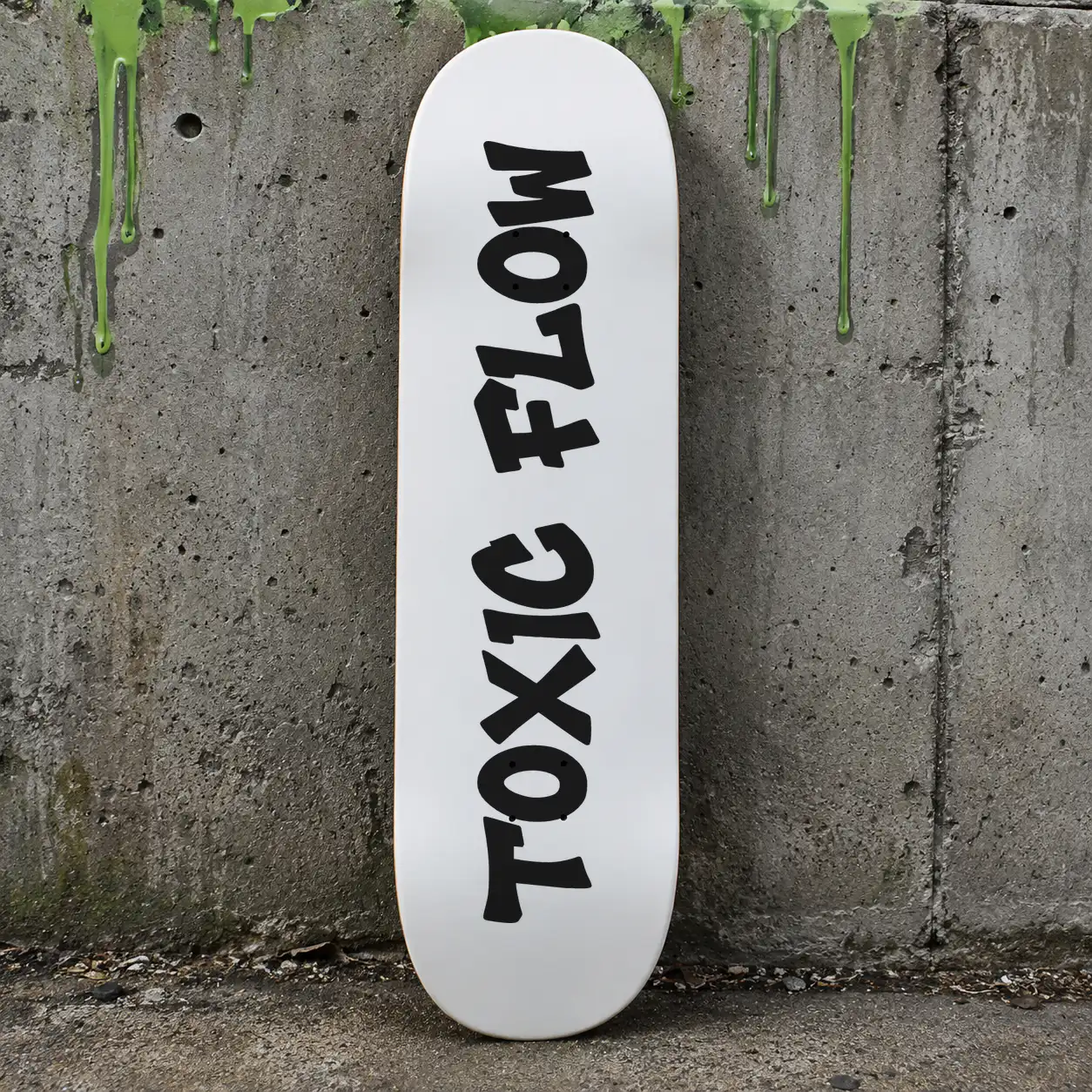 Grime Slime font on a skateboard deck reading TOXIC FLOW