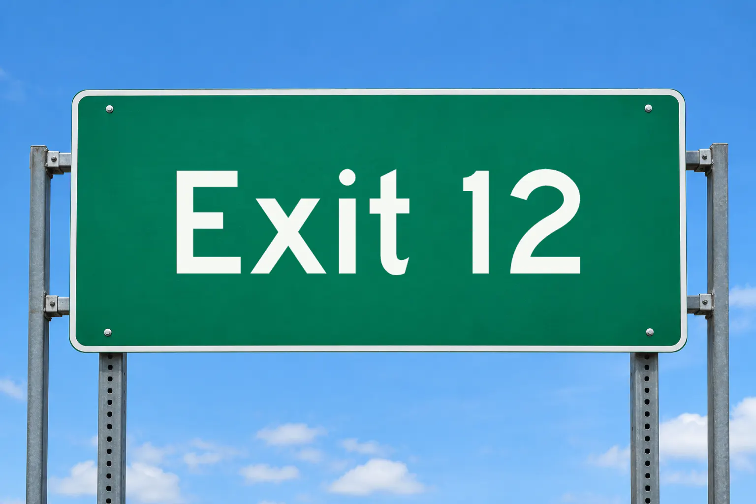 Highway Gothic font on a green highway sign reading Exit 12