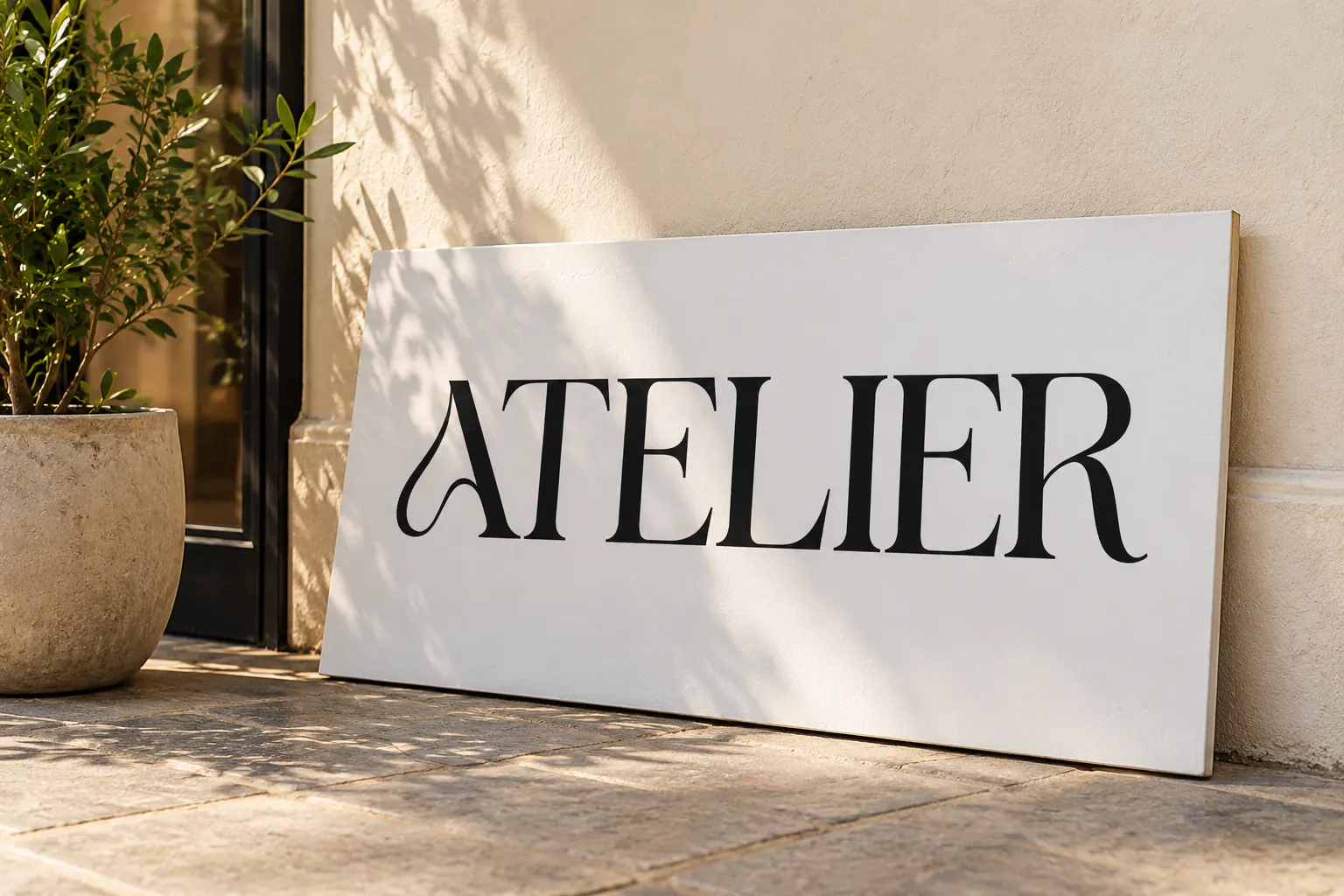 Lamoric Rowen font on a shop sign reading ATELIER