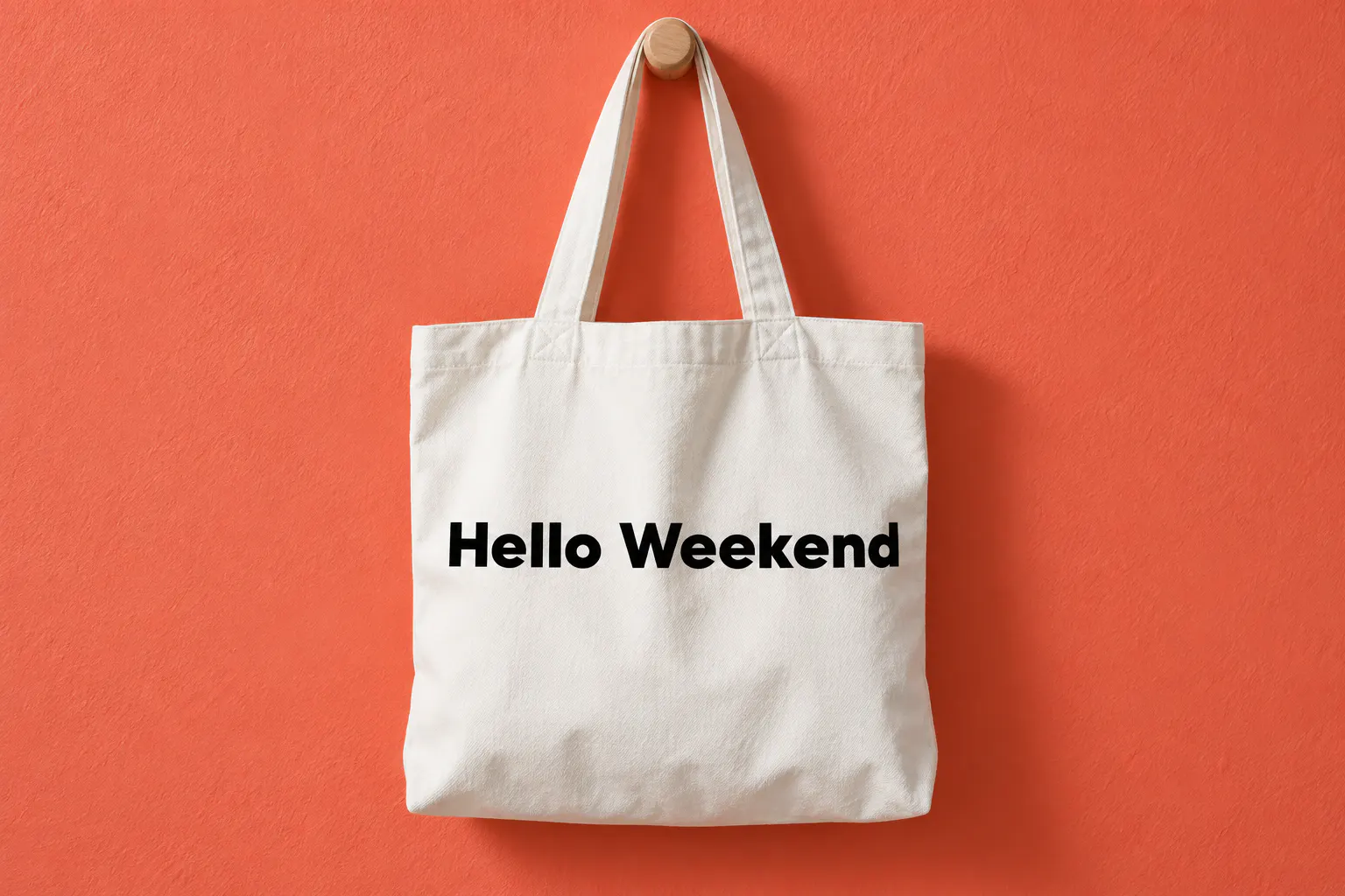 Made Tommy font on a tote bag reading Hello Weekend