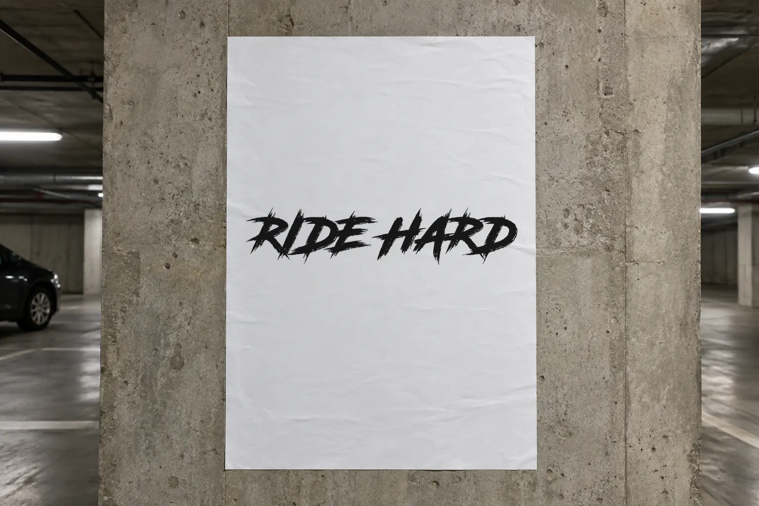 Road Rage font on a concrete wall poster reading RIDE HARD