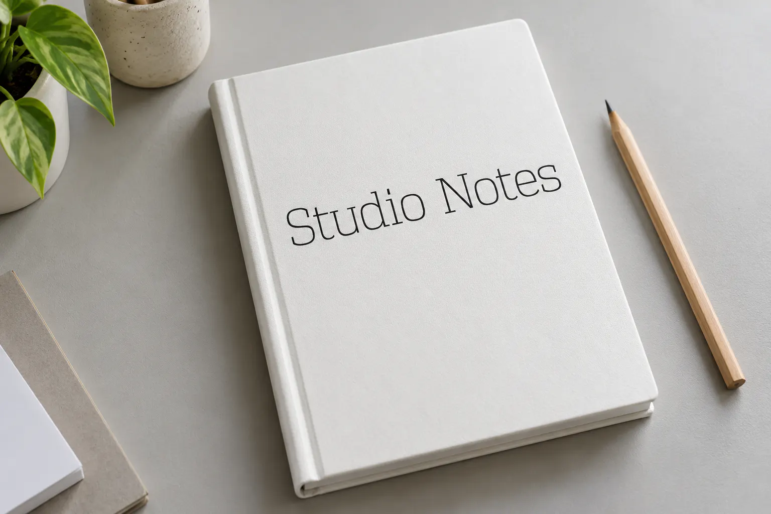 Vectipede font on a notebook cover reading Studio Notes