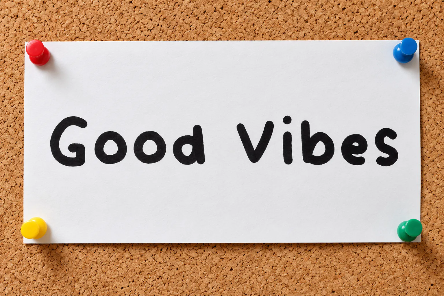 Vividly font on a pinned paper note reading Good Vibes